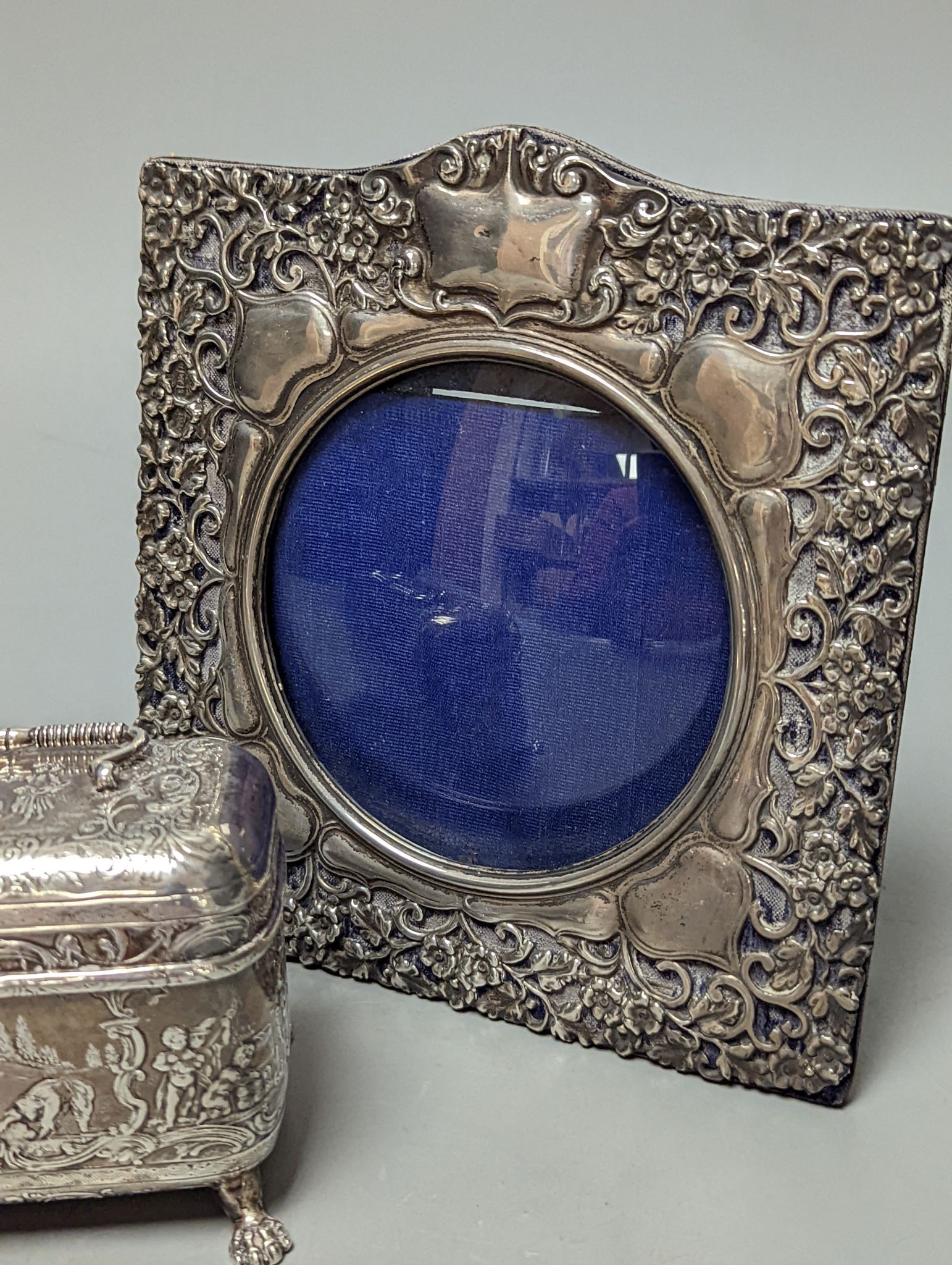An Edwardian repousse silver mounted photograph frame, Birmingham, 1901, 15.8cm and a small white metal casket.